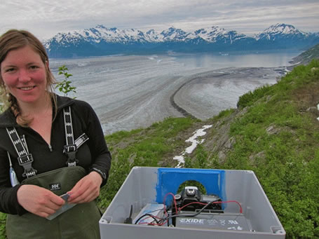 Barbara Truessel of UAF’s Geophysical Institute sets up a time lapse camera near Yakutat Glacier which will become several glaciers because of melting.  Photo by Chris Larsen. 