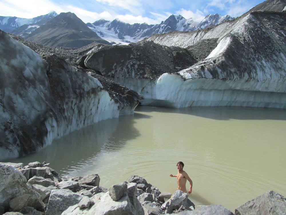 Glacier researcher Sam Herreid baths in a lake on Canwell Glacier in the eastern Alaska Range. Photo by Sam Herreid
